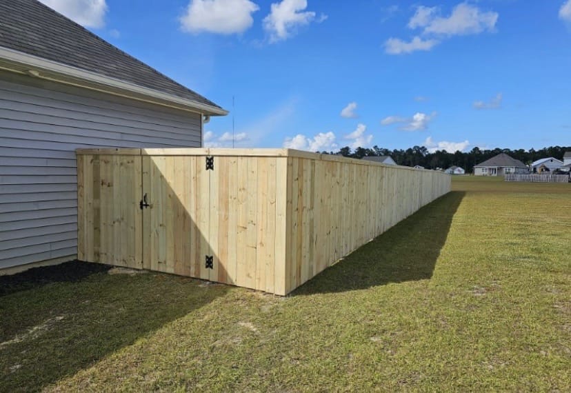 Backyard wood privacy fence with a gate in Awendaw, SC, built by Low Country Custom Outdoors